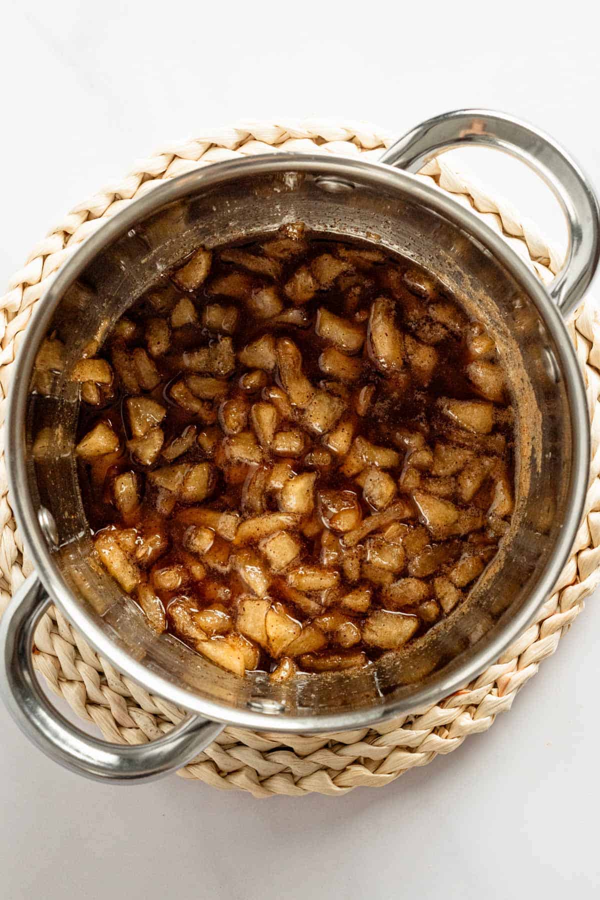 diced apple pie filling simmering in a pot.