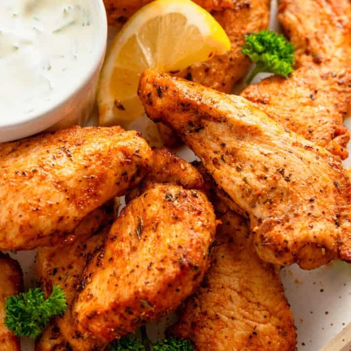 chicken tenders served with white dipping sauce.