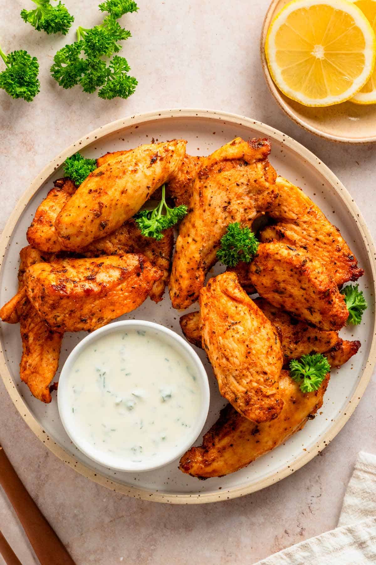 chicken tenders served with white dipping sauce.