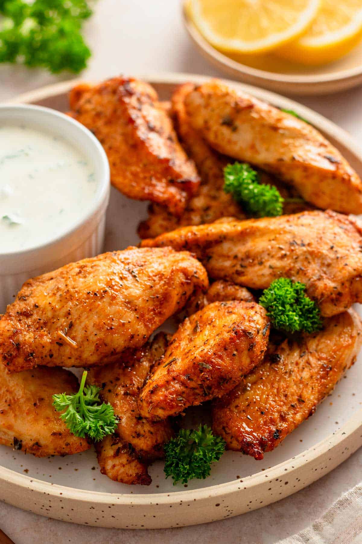 air fryer chicken tenders served with white dipping sauce.