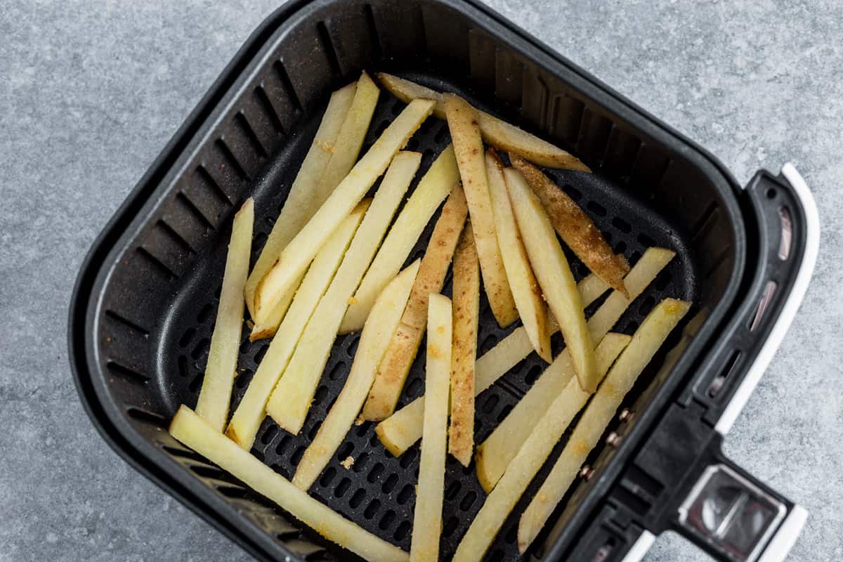 potato fries in air fryer basket before frying