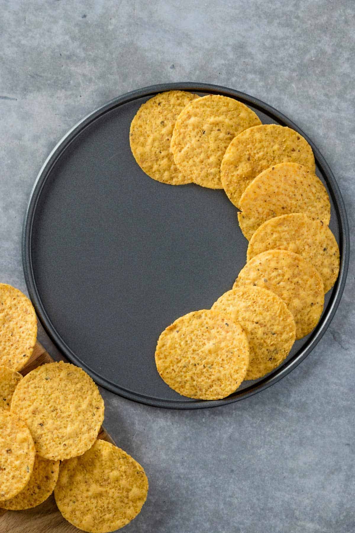 corn tortilla chips layered on a metal pan