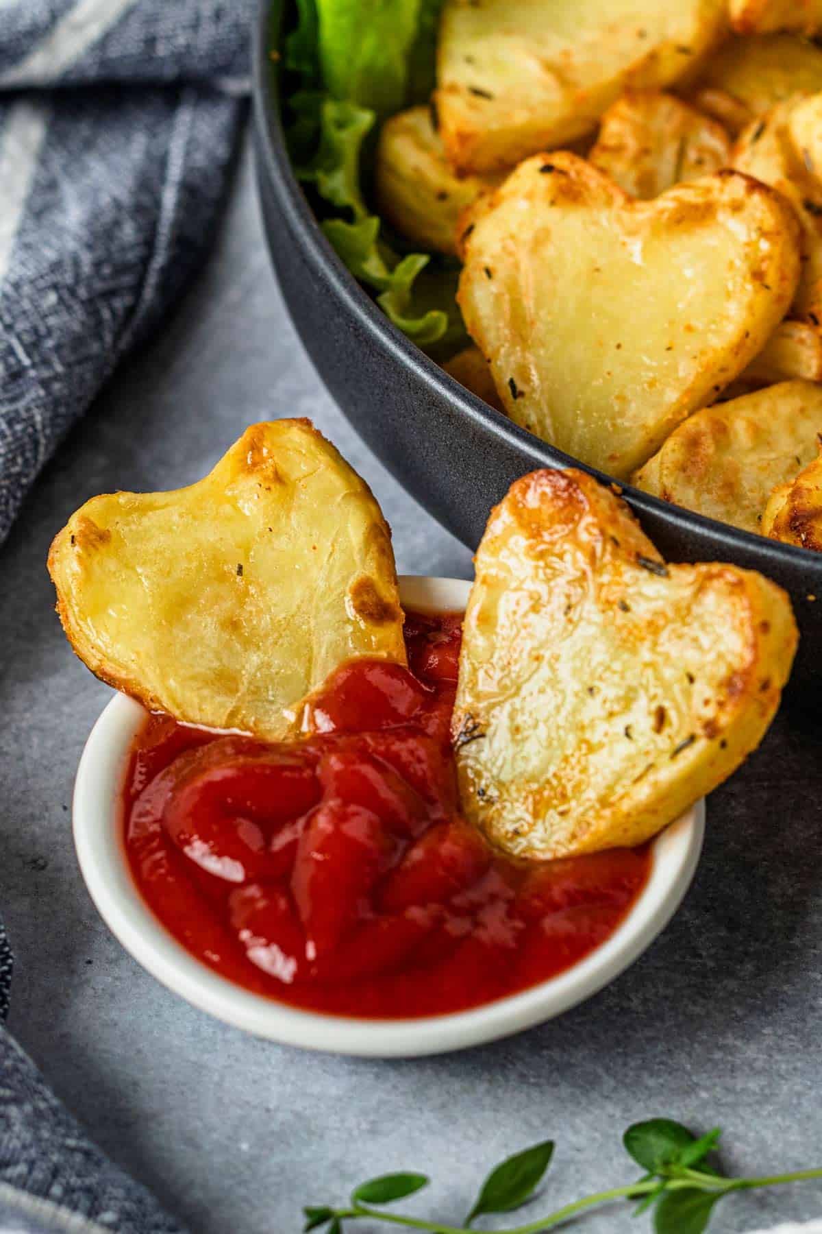 heart shaped potatoes in a plate with ketchup