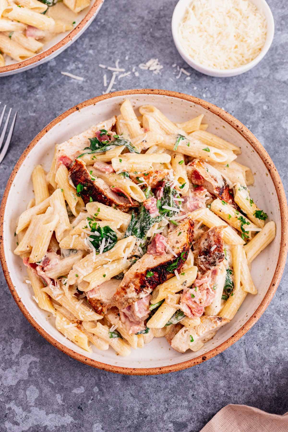 This Creamy Chicken Bacon And Spinach Pasta is one of our all-time favorite dinner recipes. Tender juicy chicken over pasta in a rich creamy sauce with spinach and bacon. An excellent easy weeknight or weekend dinner recipe for the whole family. Yum! - The Yummy Bowl