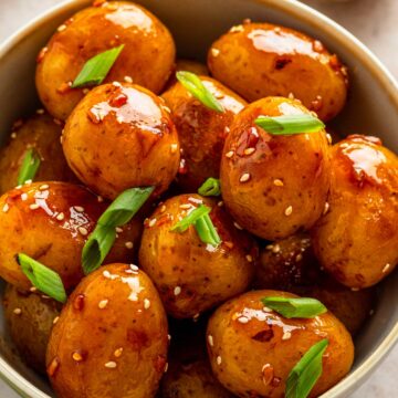 baby potatoes with dark sauce in skillet.