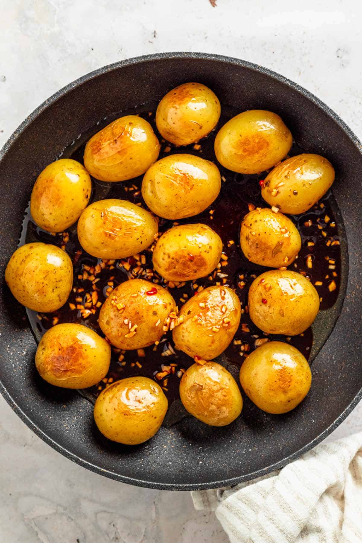a skillet full of skin on baby potatoes/