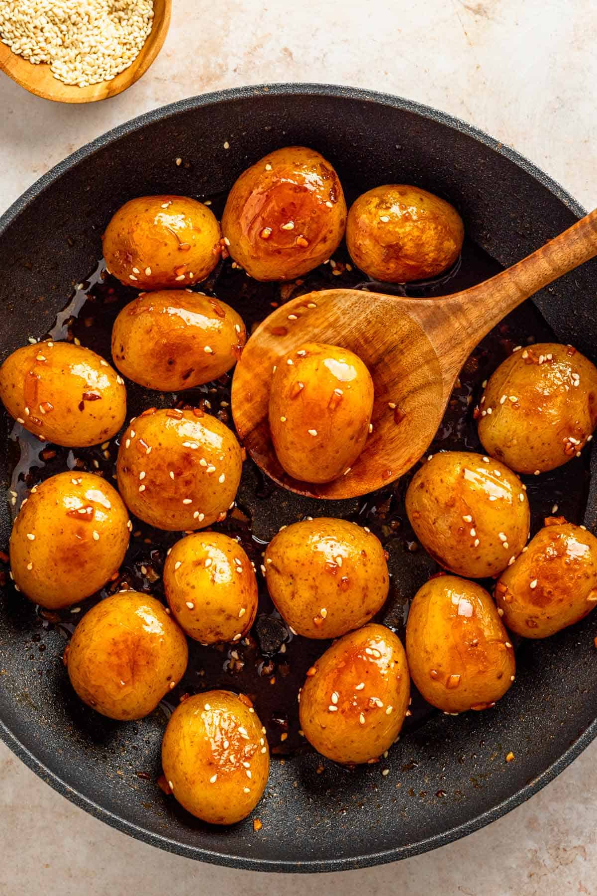 baby potatoes with dark sauce in skillet.