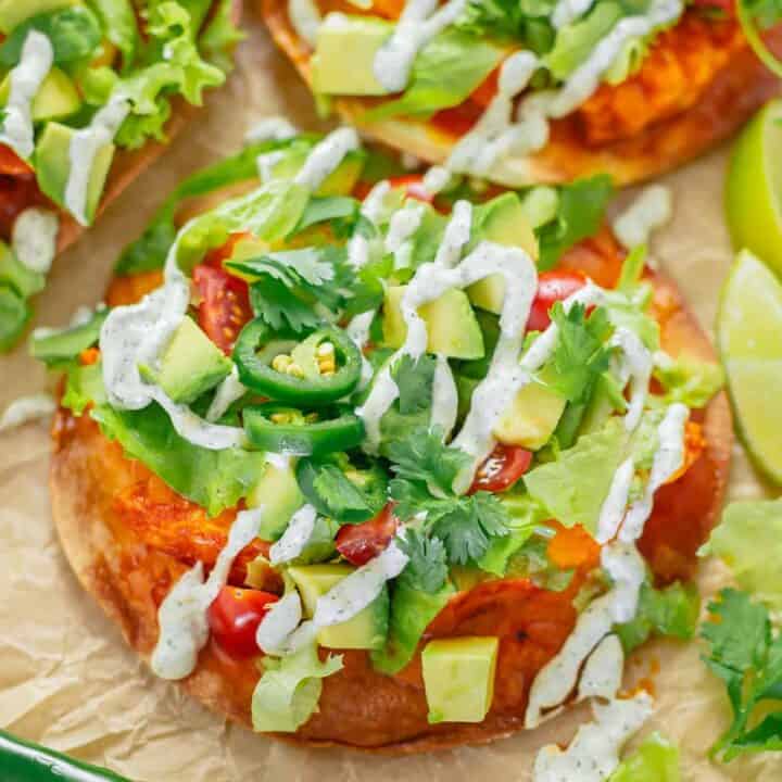 crispy tostadas with buffalo chicken toppings and ranch dressing close up shot