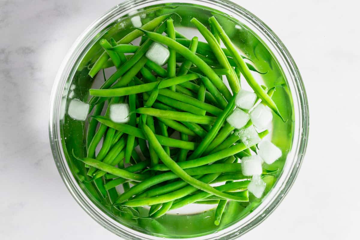 beans in water bath with ice cubes.