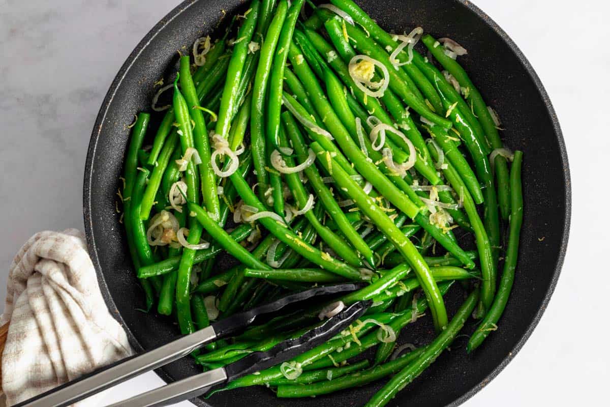 green beans cooking in the skillet.