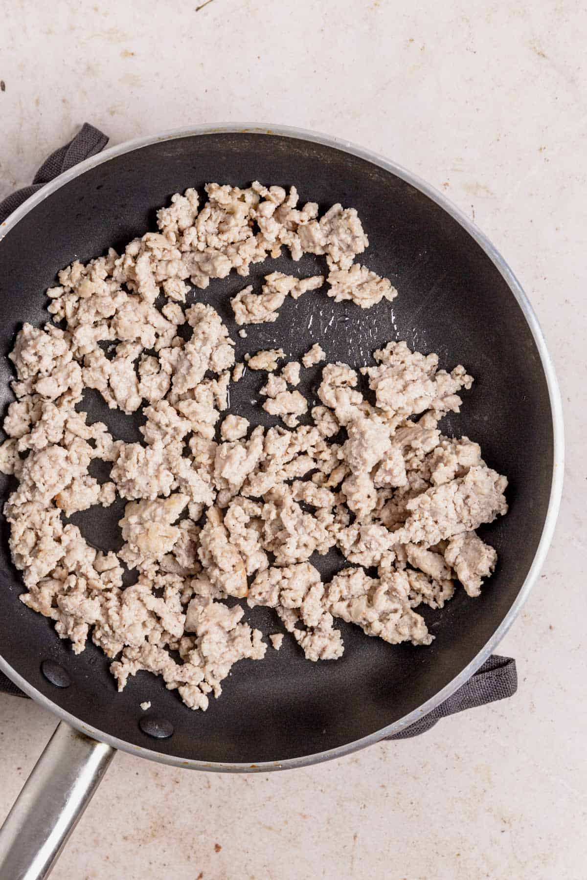 ground chicken cooking in skillet