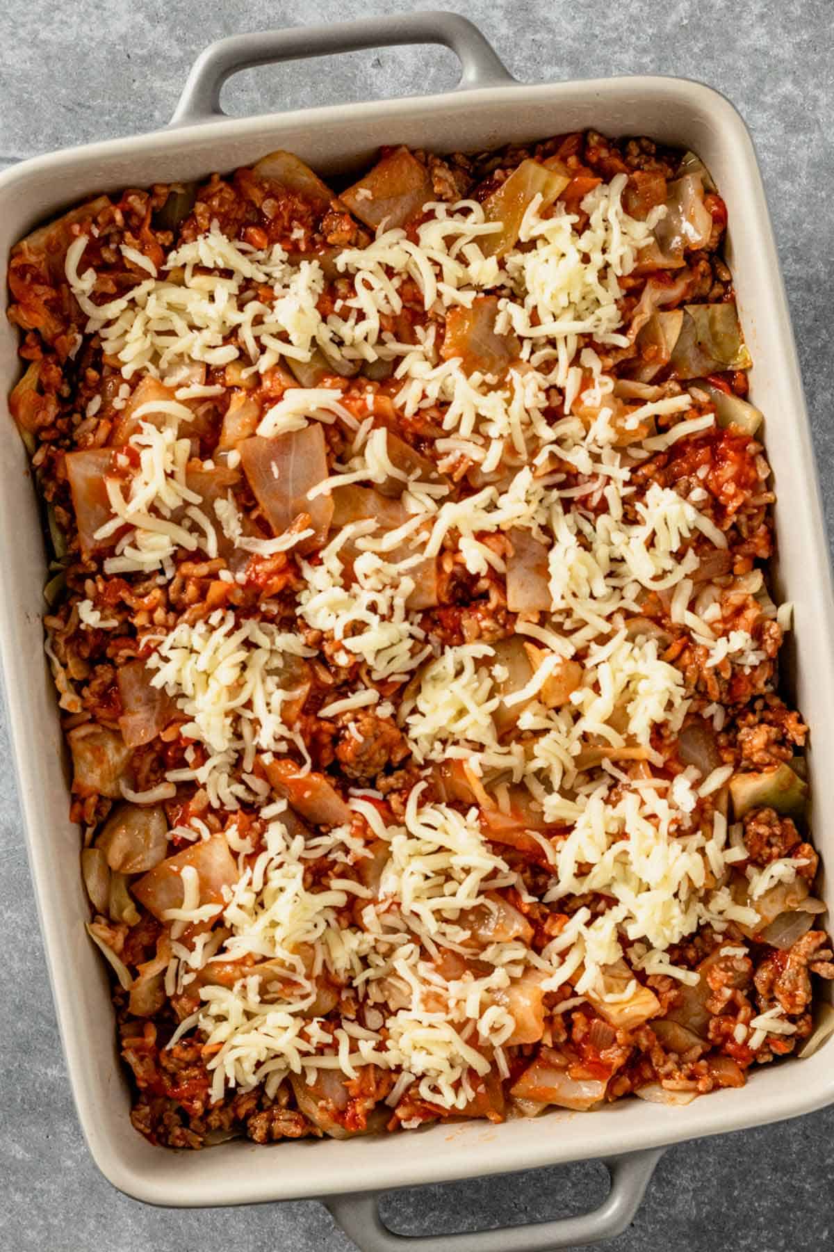 cabbage casserole sprinkled with mozzarella cheese before baking