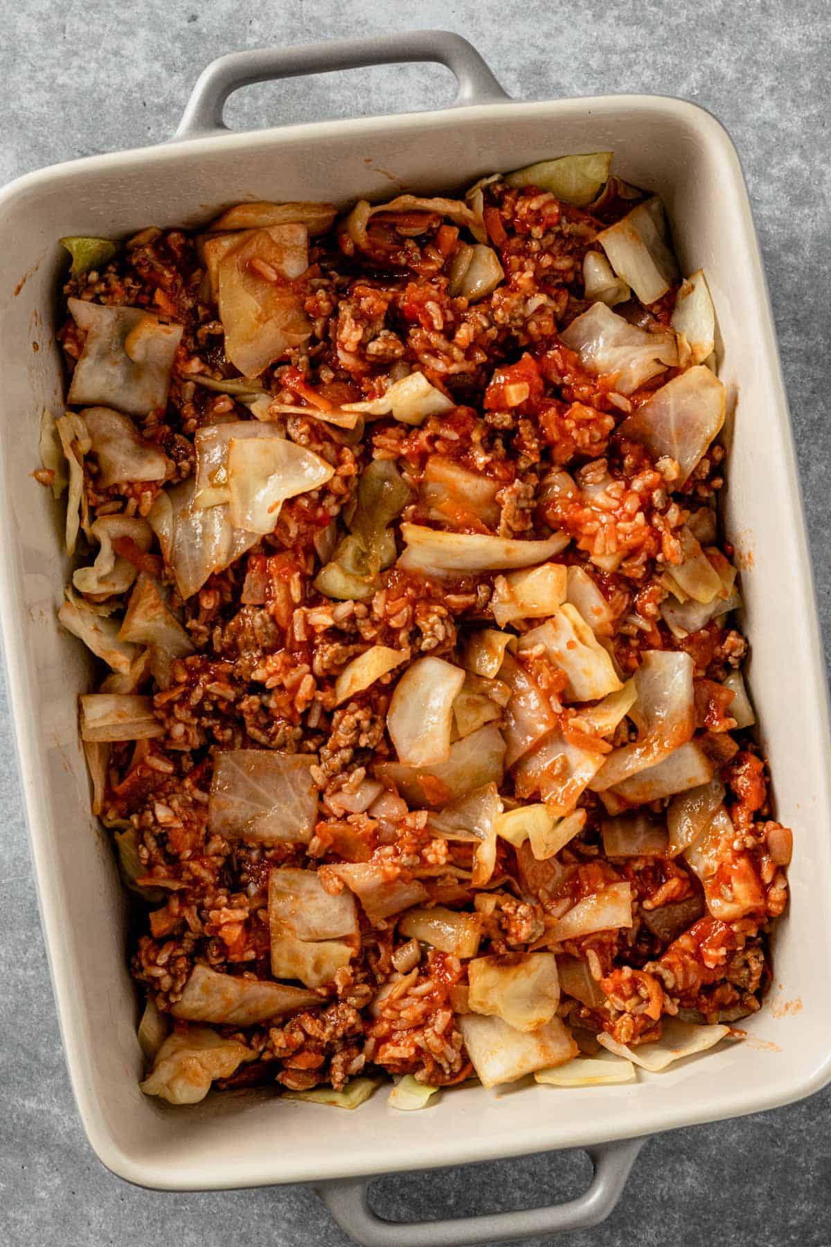 layers of ground beef and cabbage mixture in casserole dish