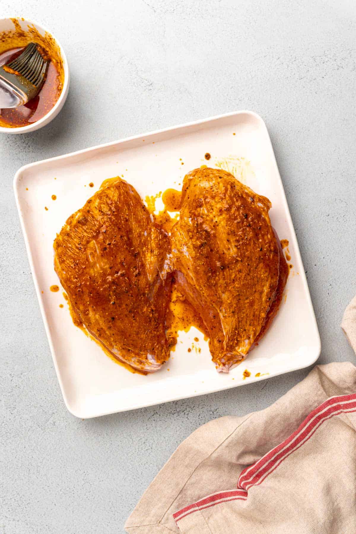 brushing the turkey breasts with seasoning and butter.