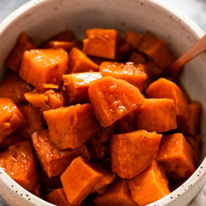 sweet potato cubes in a bowl in sugary syrup.