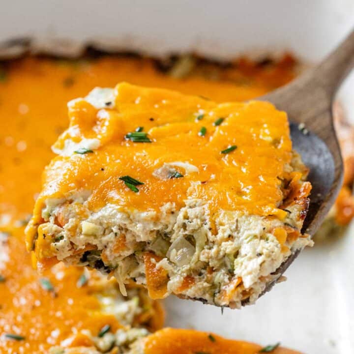 zucchini chicken casserole closeup on a wooden spoon