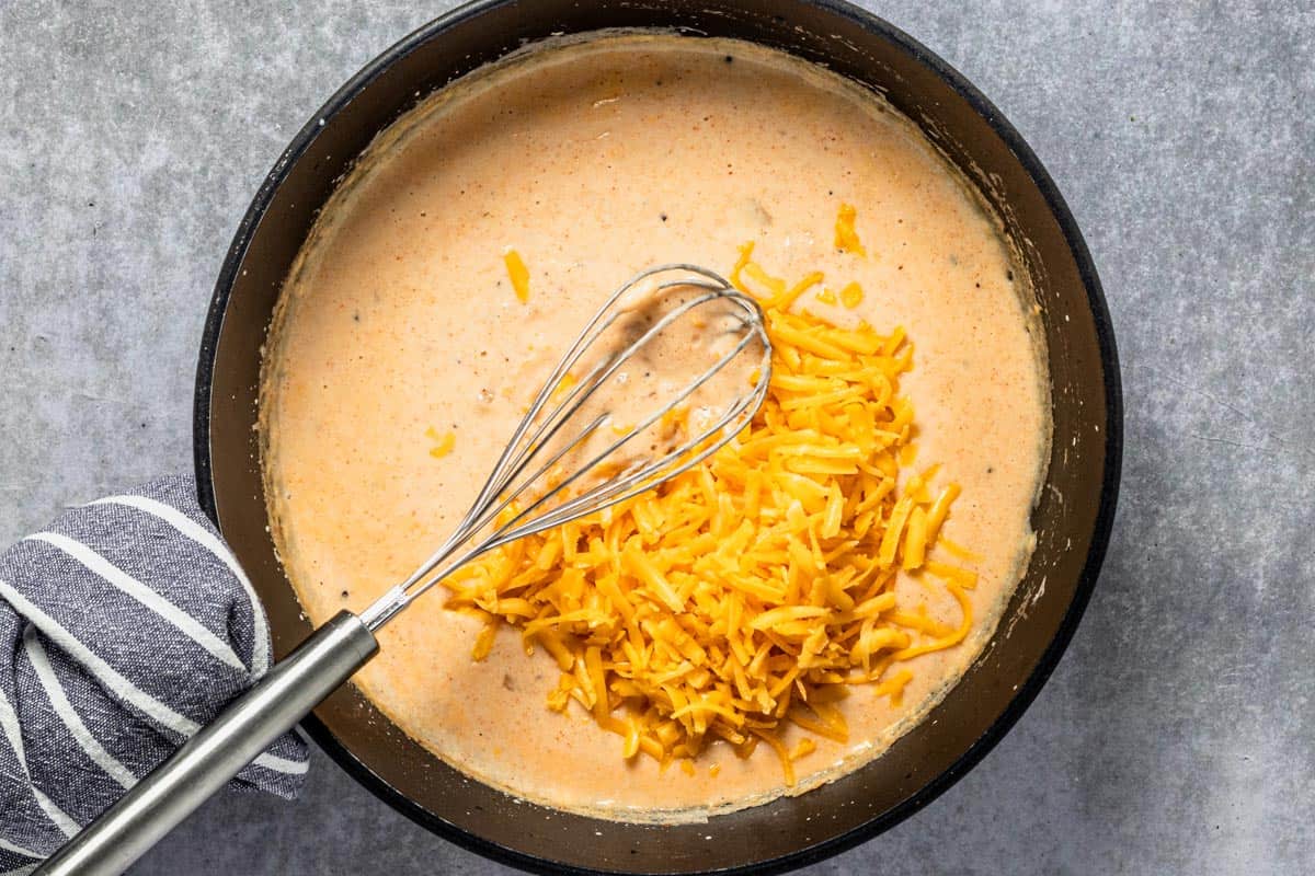 creamy sauce in skillet with cheddar