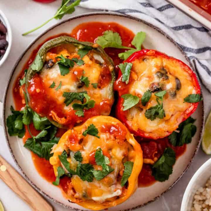 three stuffed bell peppers on a plate