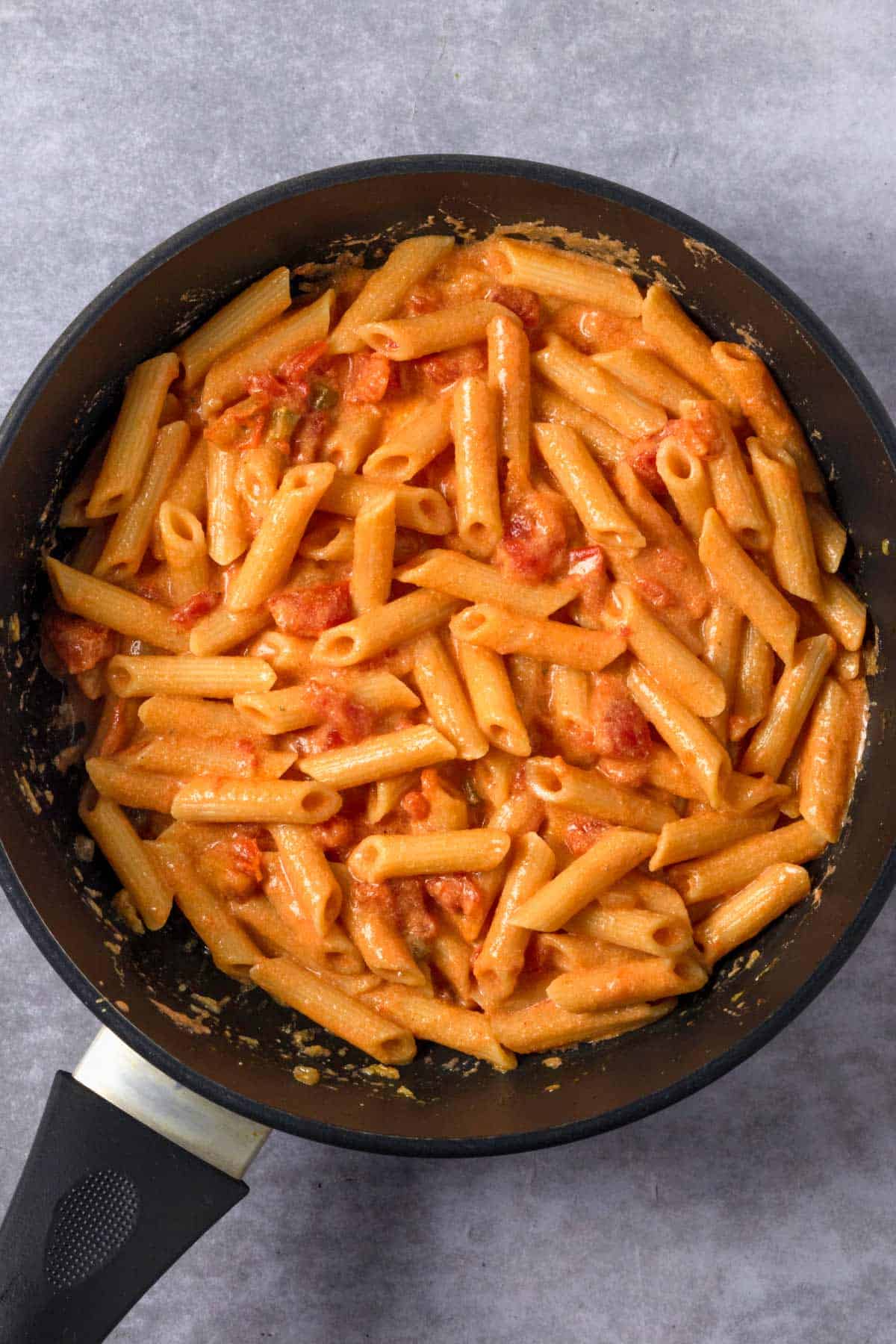 pasta and crushed tomatoes in a skillet