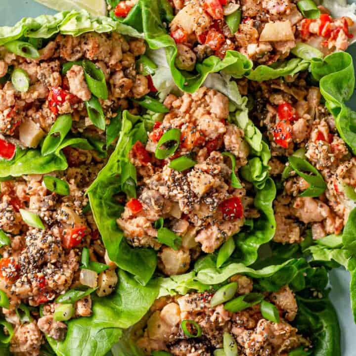 picture of chicken lettuce wraps stacked together on a blue plate