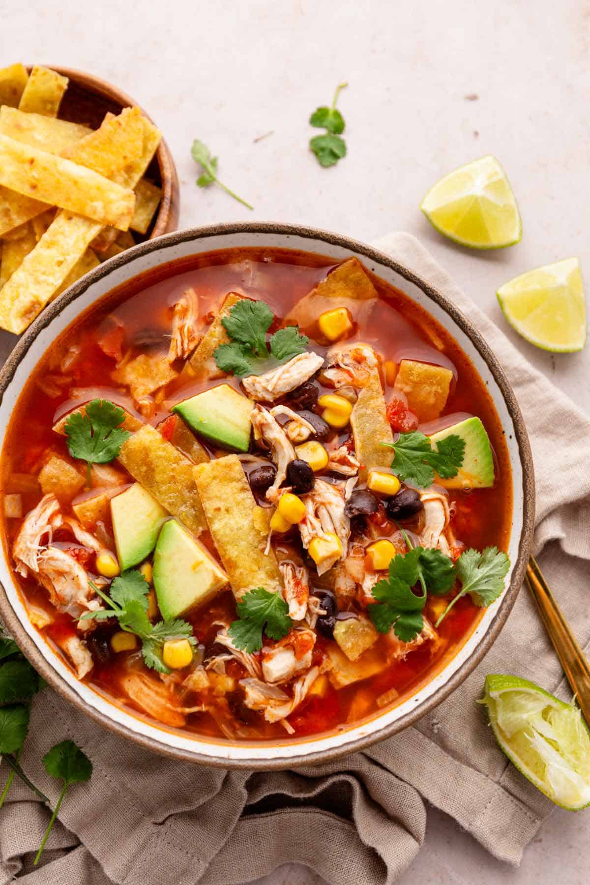 chicken tortilla soup with avocado slices, tortilla strips.