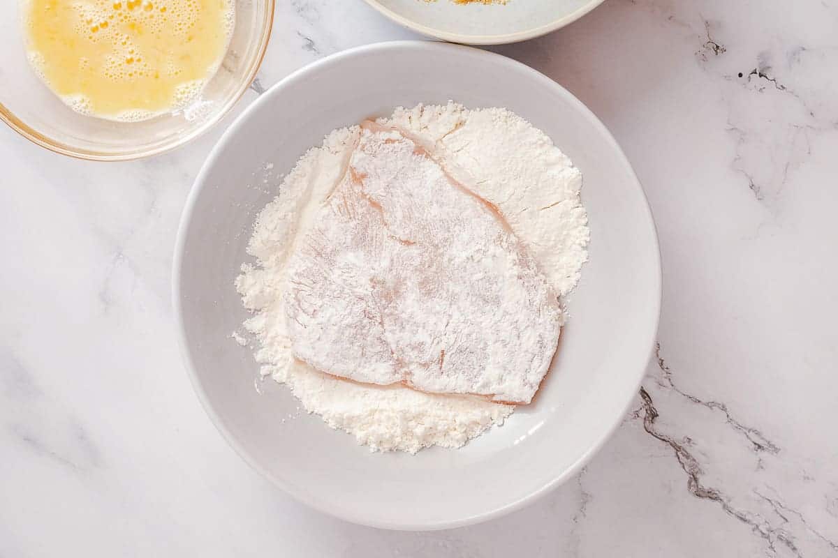 chicken breast coated in flour bowl