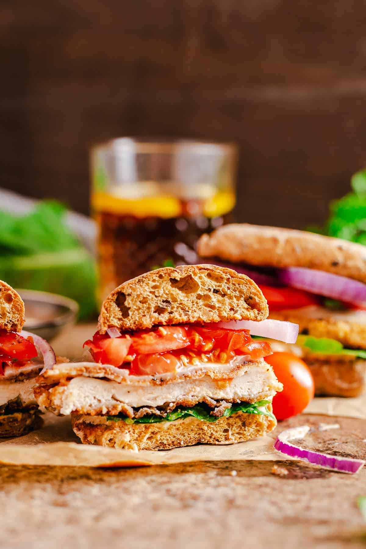 chicken ciabatta sandwich cut out shot over dark background