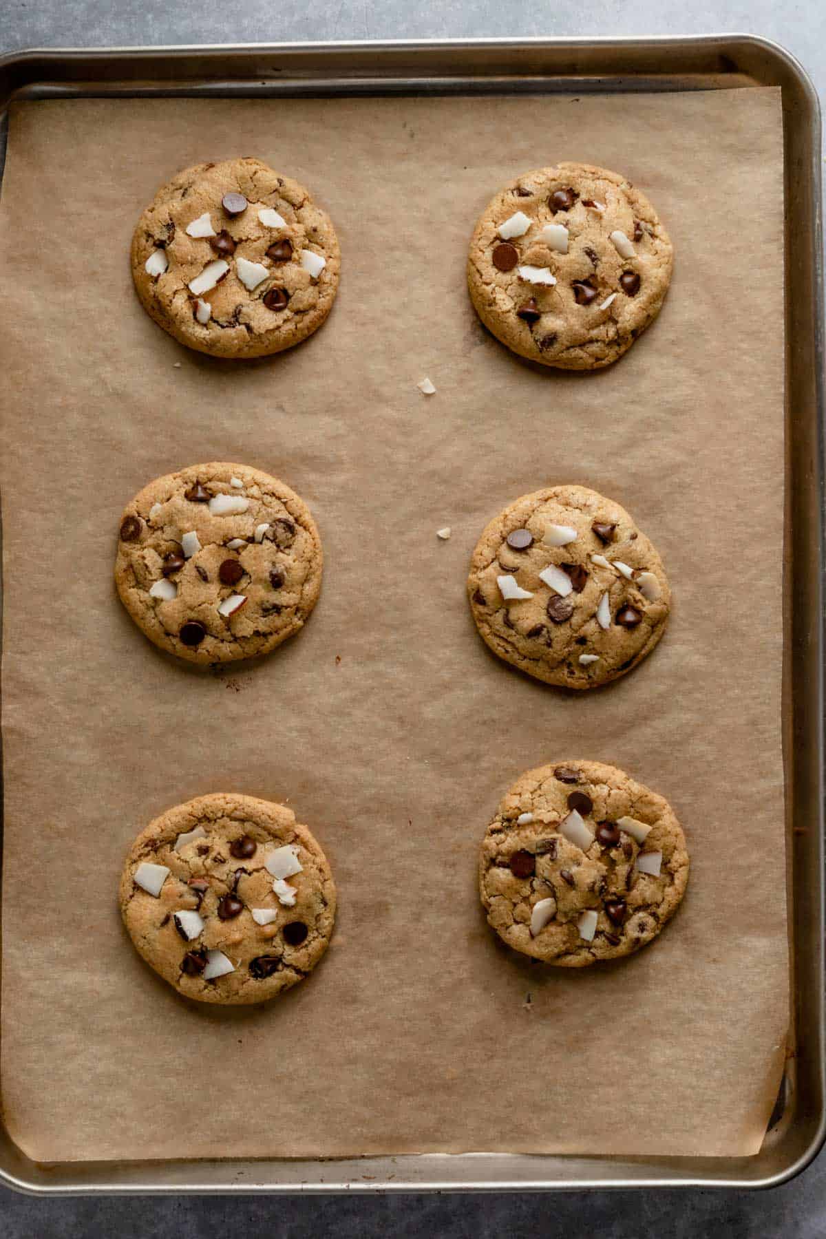 freshly baked coconut chocolate chip cookies on baking sheet