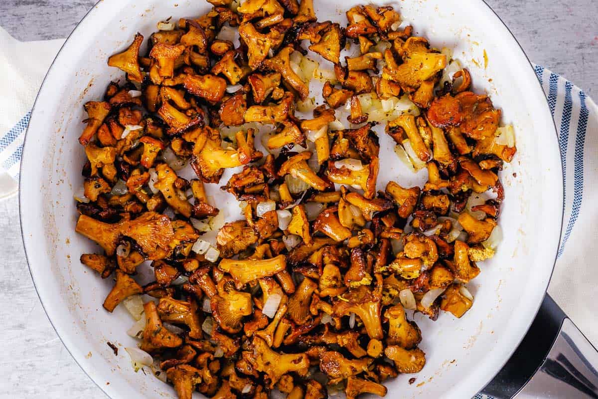 chanterelle mushrooms cooked with butter in a white pan