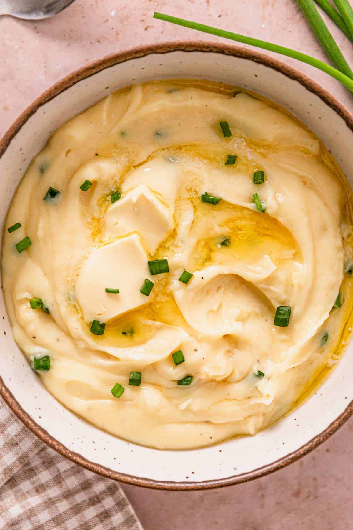 crock pot mashed potatoes in a bowl with green onions