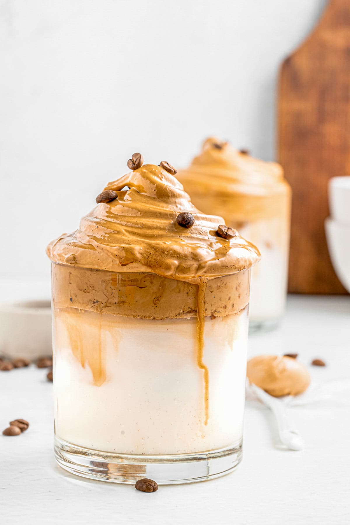 This Dalgona Whipped Iced Coffee recipe calls for four simple ingredients to make the best homemade iced coffee drink. Indulge yourself in the most delicious iced drink with fluffy clouds of whipped coffee over milk. An easy, creamy and superb refreshing drink to enjoy this summer. It only takes about 5 minutes to whip up! - The Yummy Bowl