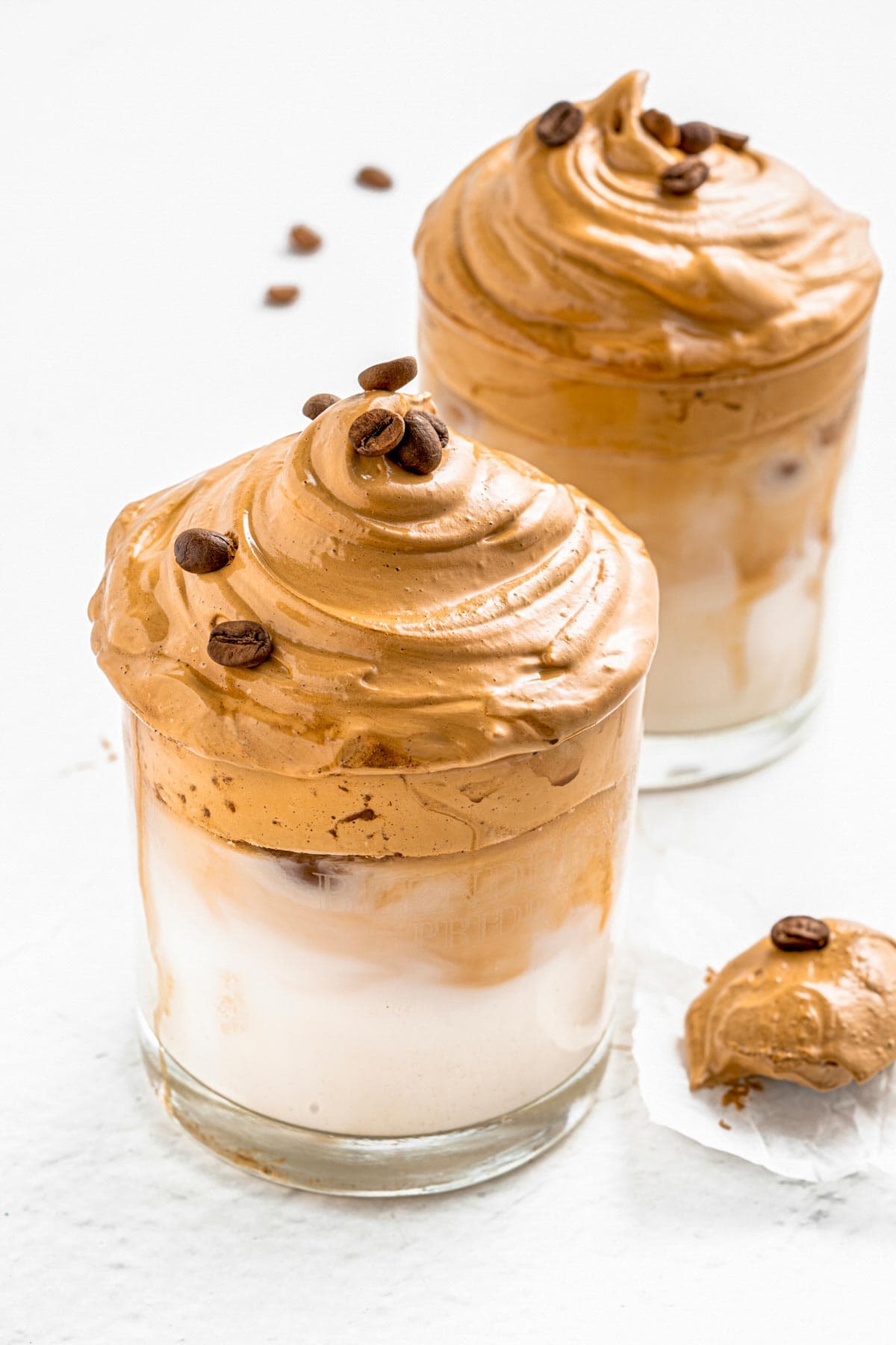 whipped instant coffee and milk in a glass mug.