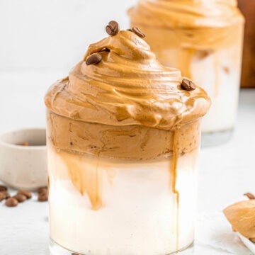 whipped instant coffee and milk in a glass mug.