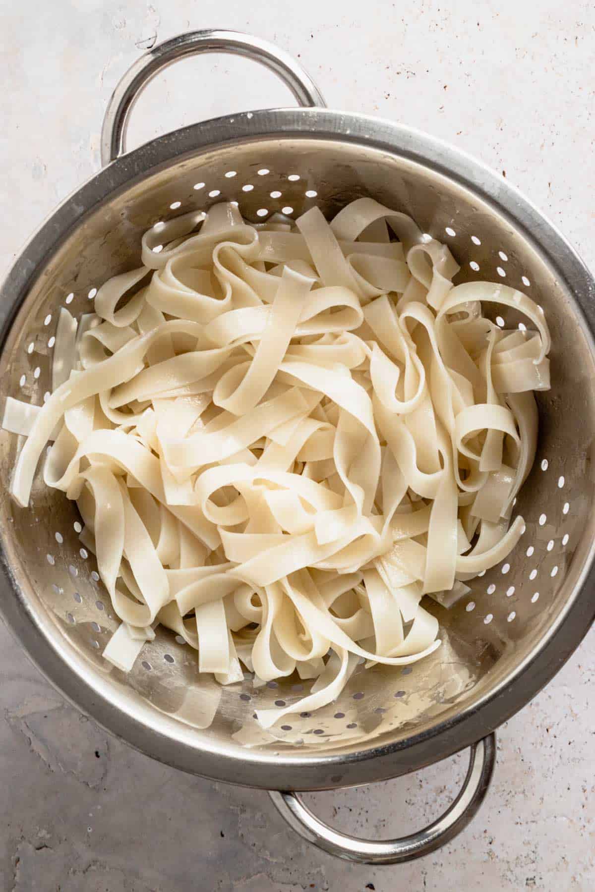 rice noodles in colander.