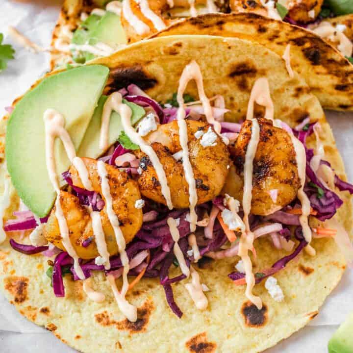 close up shot of grilled Shrimp Tacos with spicy mayonnaise and coleslaw