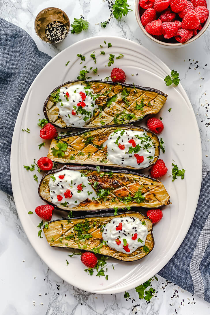  Oven-Roasted Eggplant boats loaded with yogurt and goat cheese dressing and a bit of raspberry together create a delicious and delicate flavor that almost asking to be eaten immediately. 