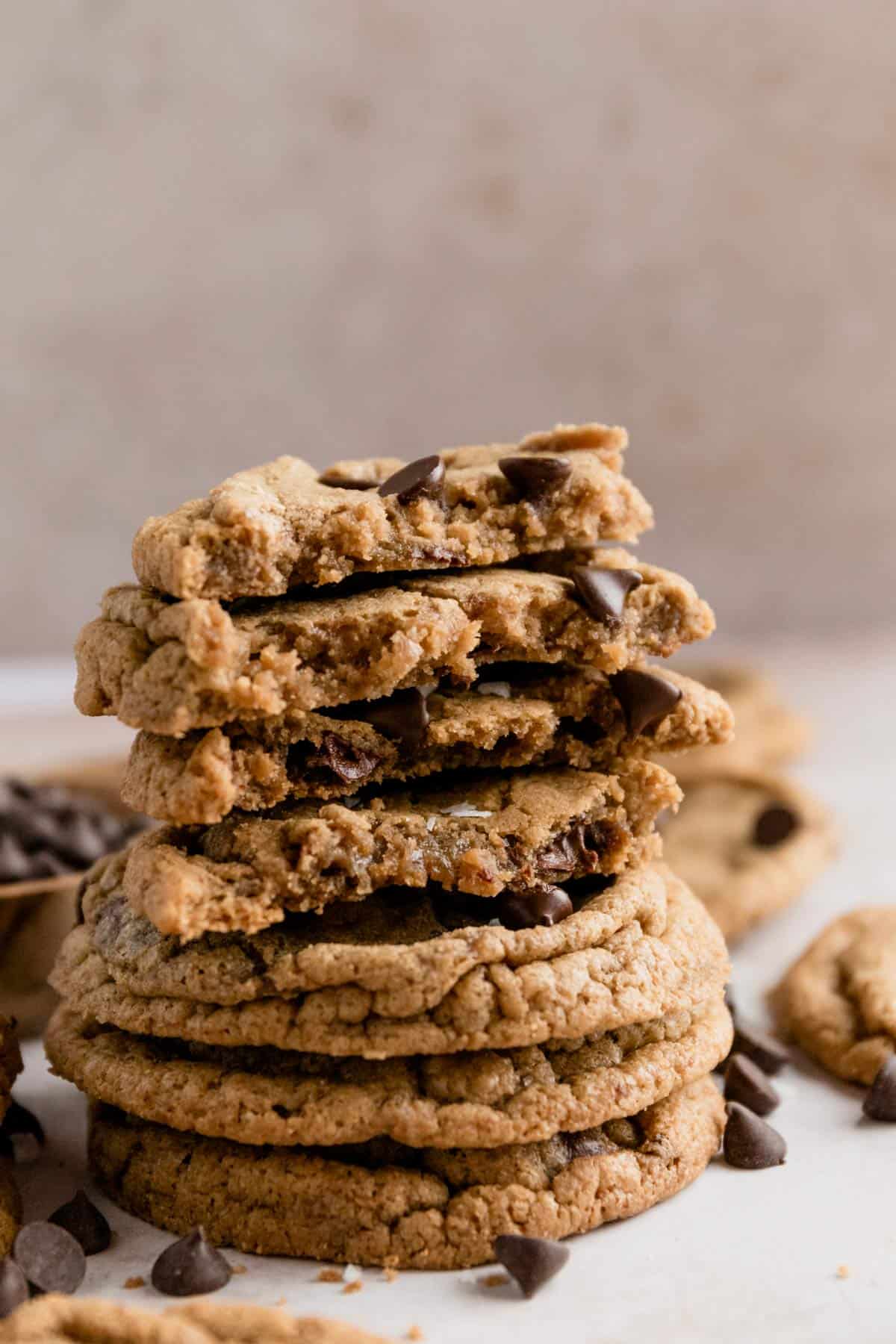 a stack of cut in half gluten free chocolate chip cookies with sea salt flakes