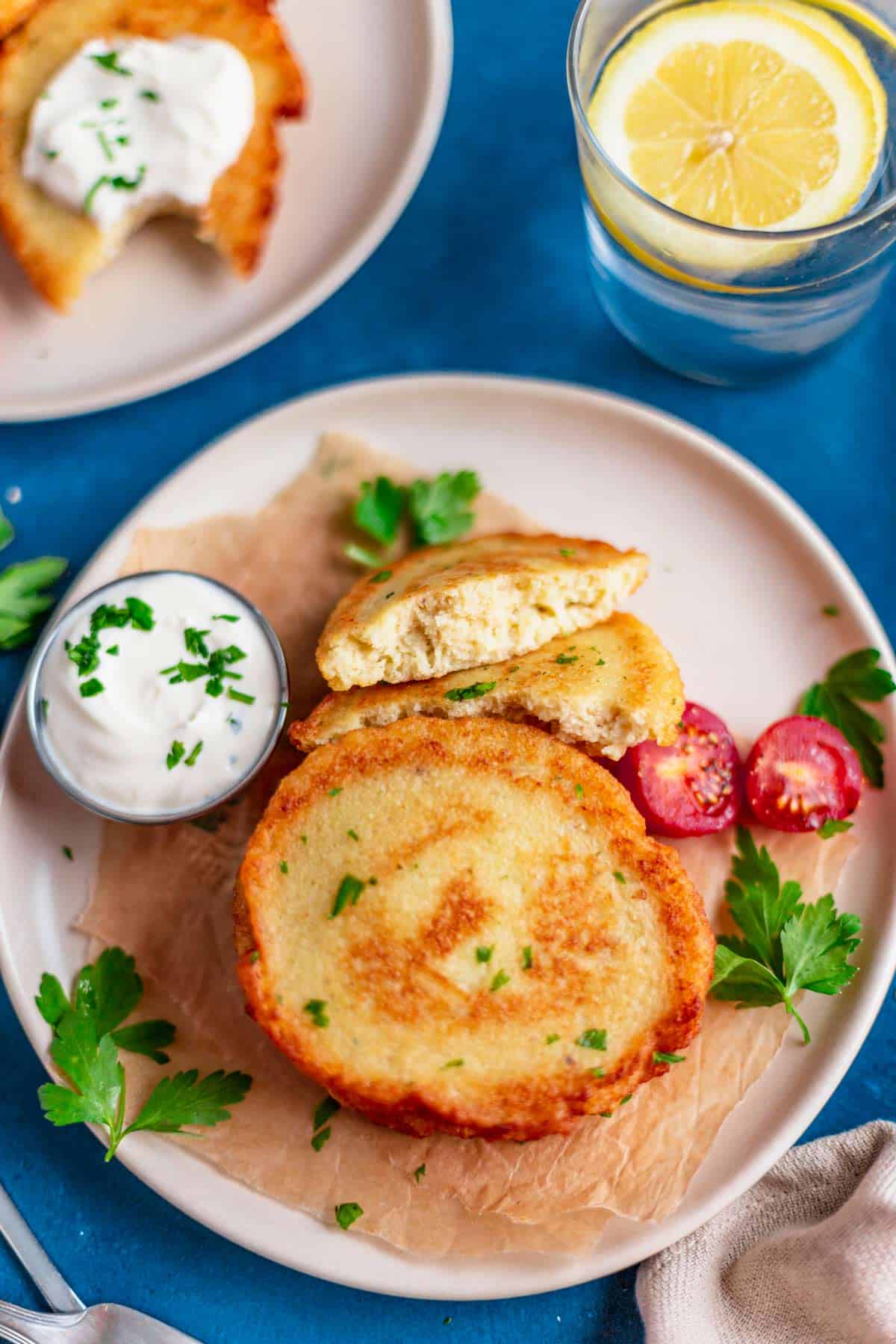 gluten free potato pancakes on a plate with sour cream