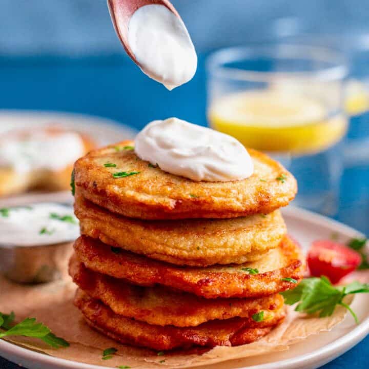 stack of gluten free potato pancakes with sour cream