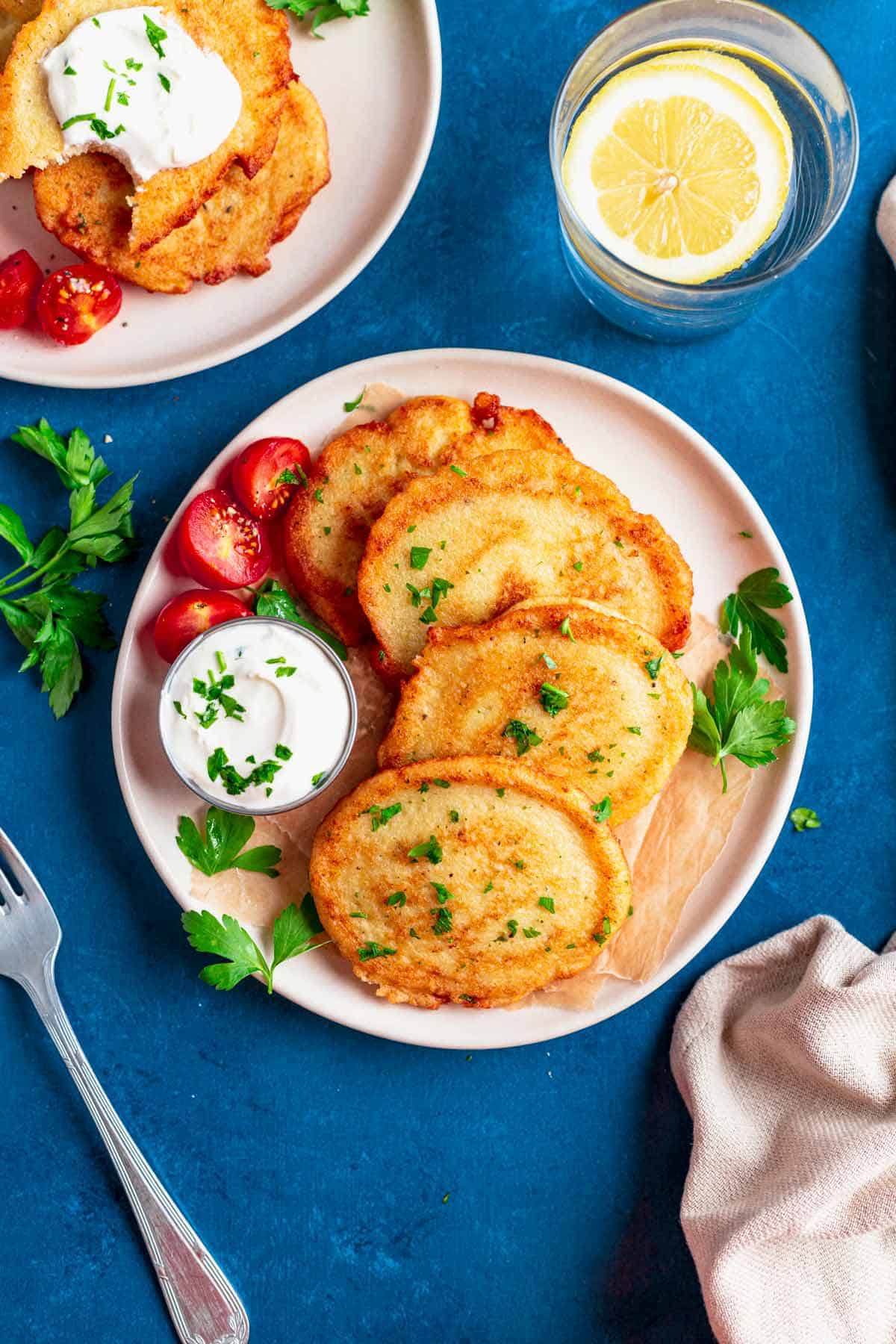 gluten free potato pancakes on a plate with sour cream