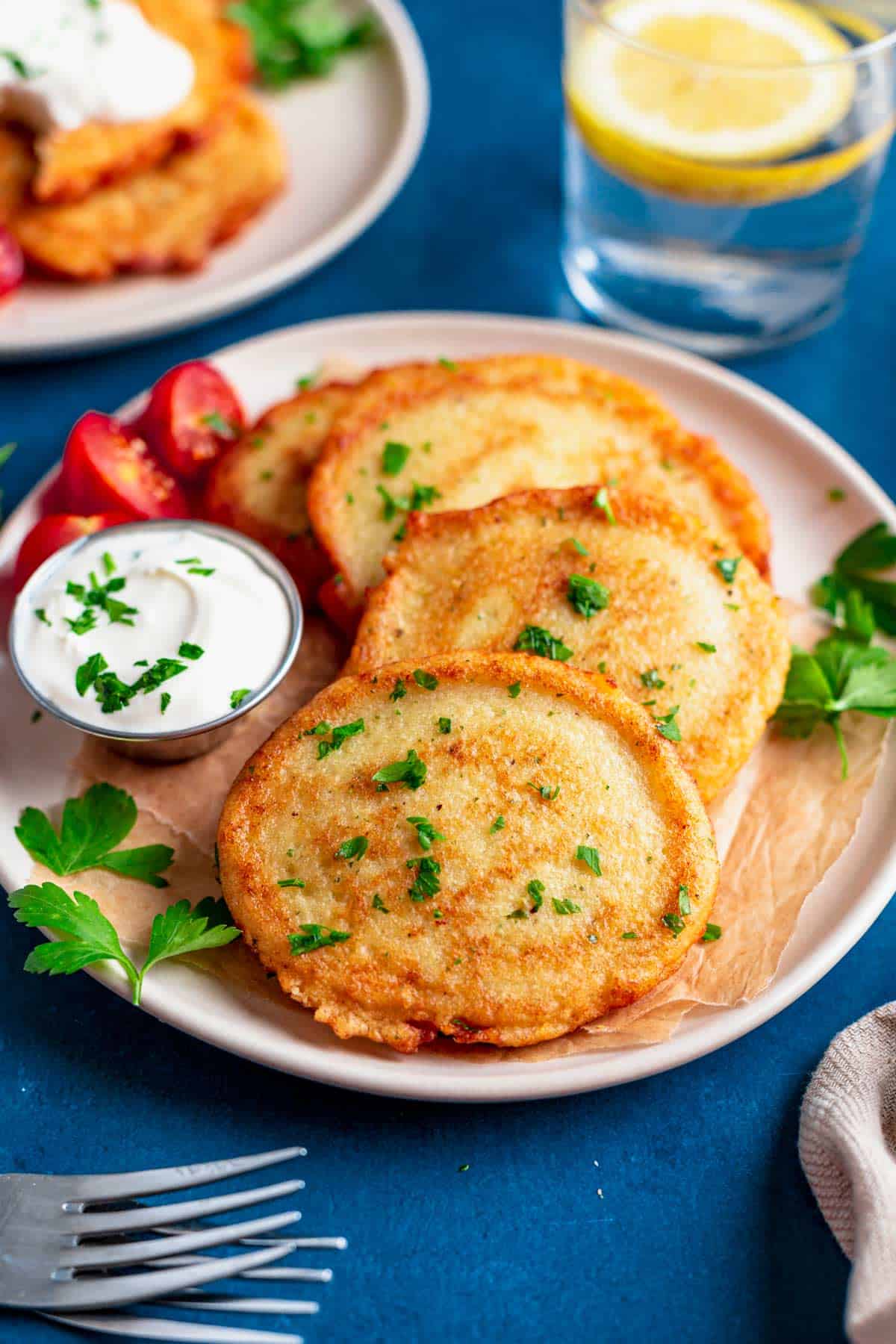 gluten free potato pancakes on a plate with sour cream