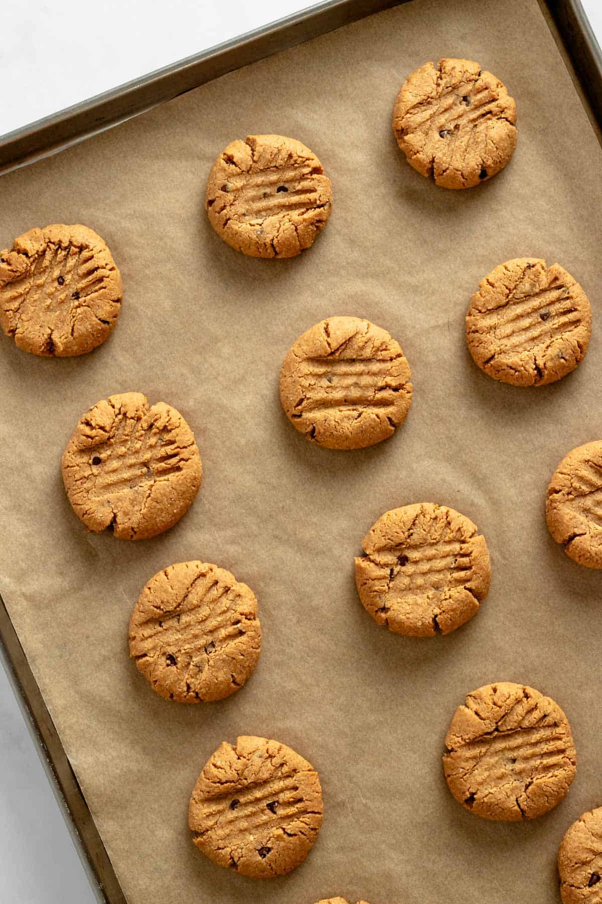 baked peanut butter cookies on a baking sheet.