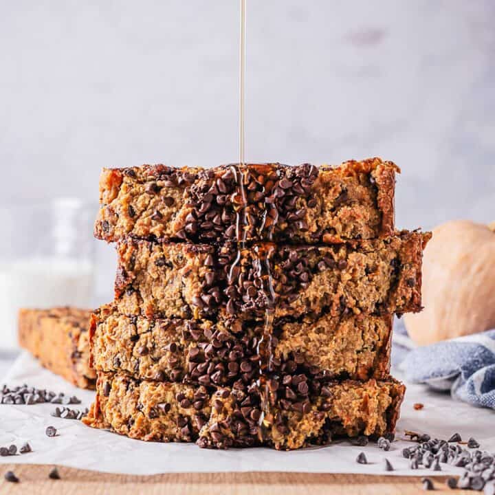 maple syrup drizzled on top of stack of pumpkin bread