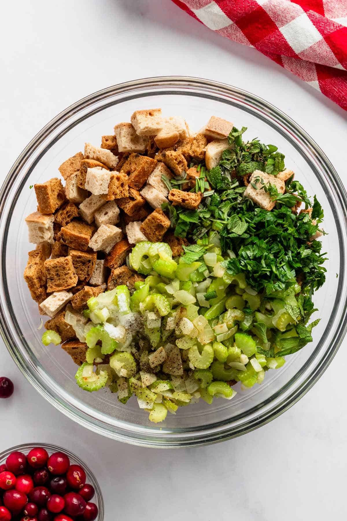 toasted bread, veggies and herbs in a bowl for stuffing.