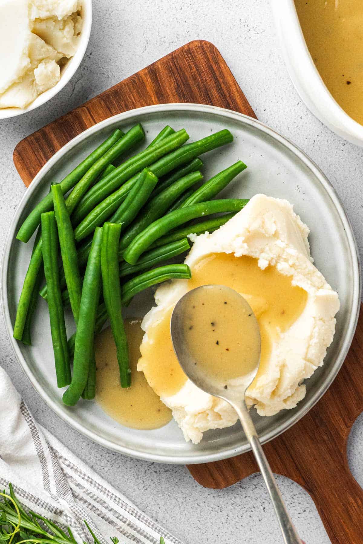 gravy served with mashed potatoes and green beans.