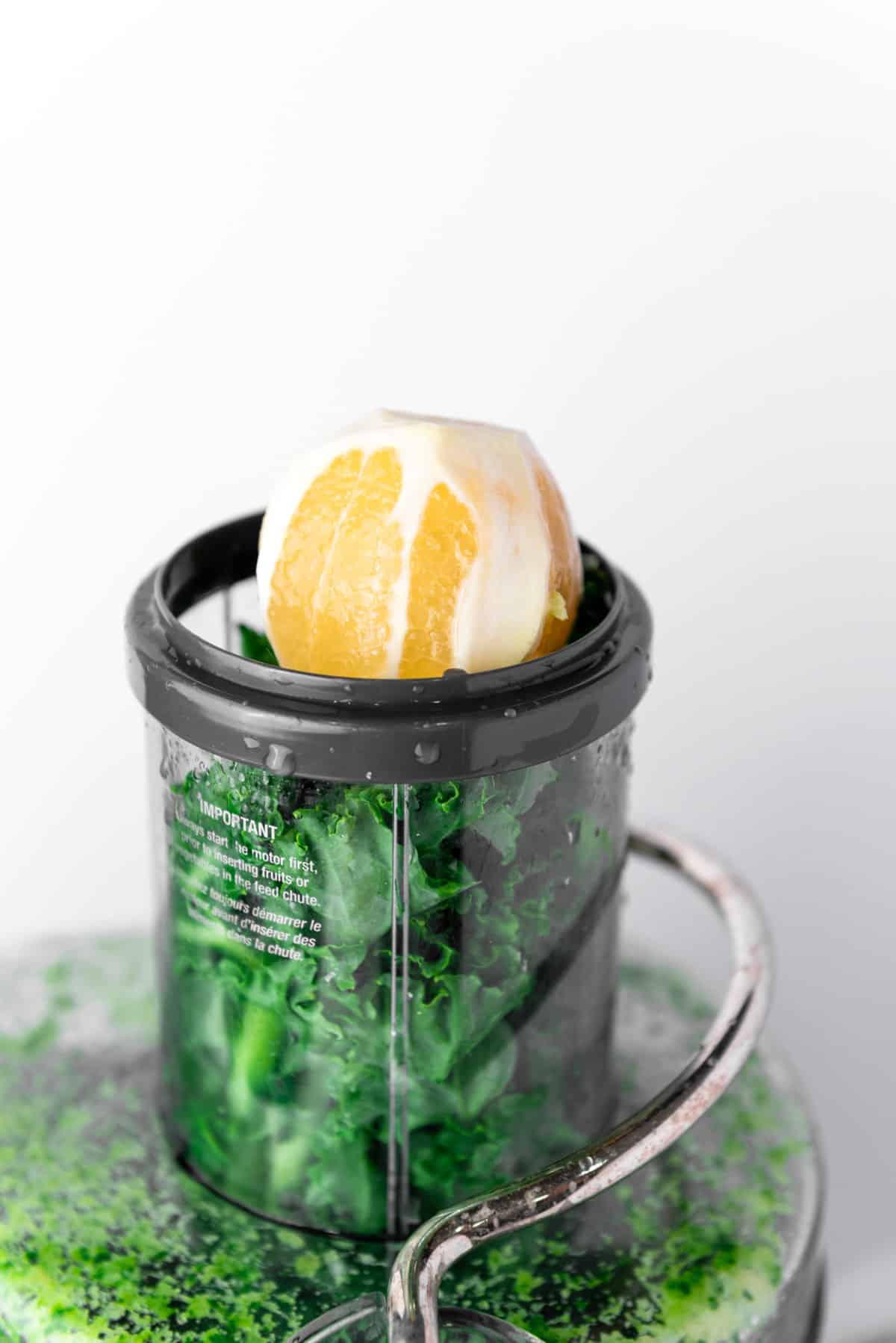 lemon and kale in juicer