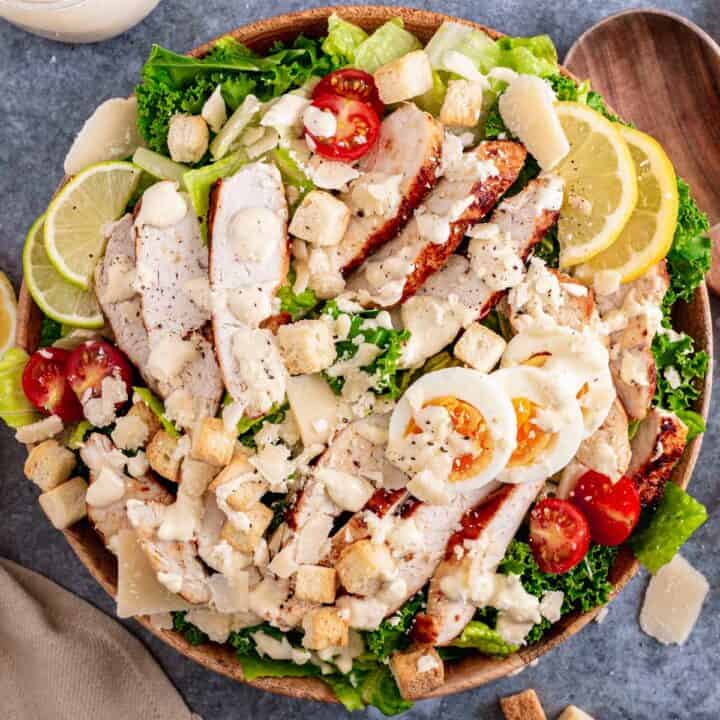 Lemon Kale Caesar Salad with chicken in a white bowl