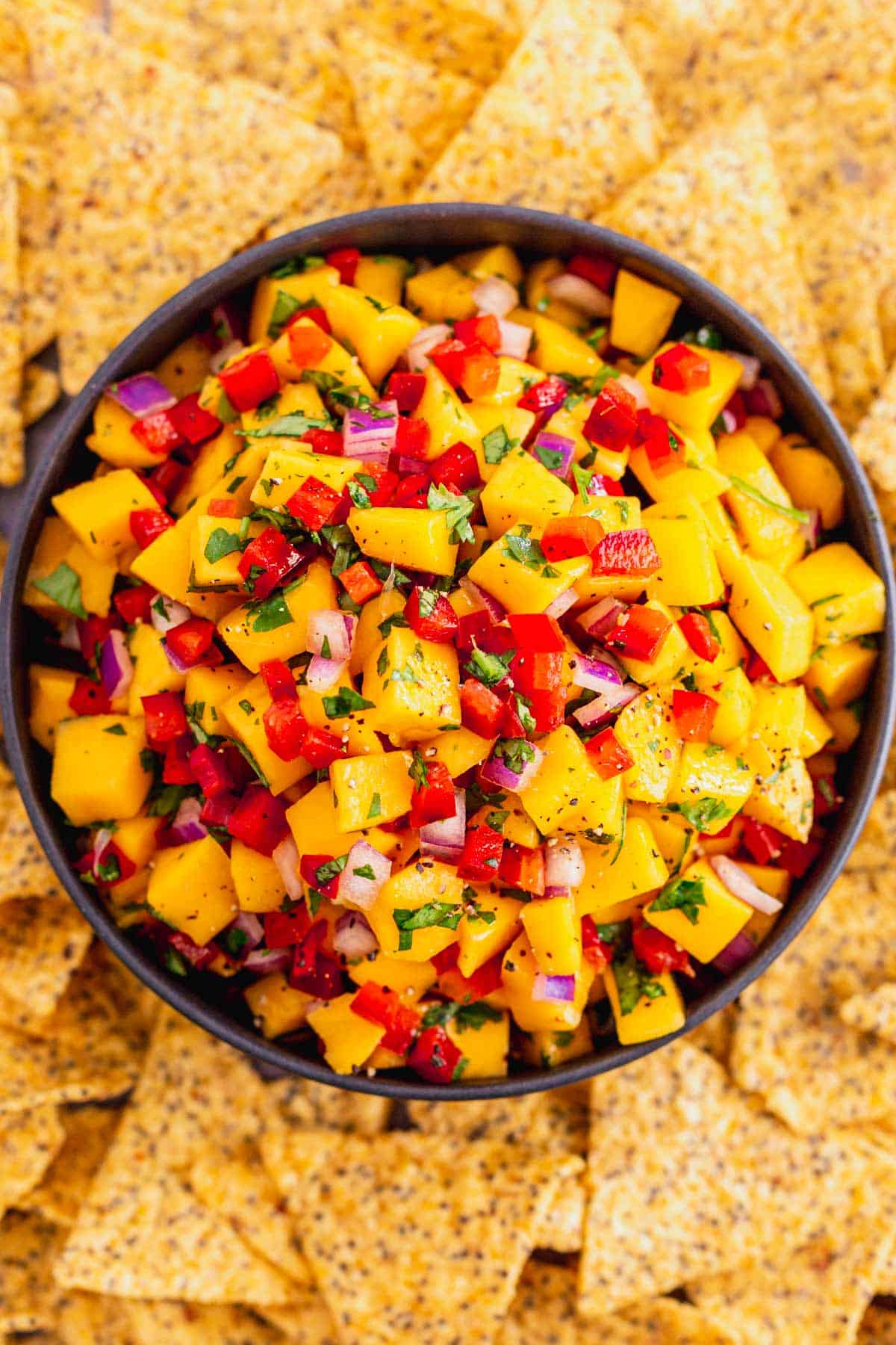 mango salsa ingredients all mixed up in white bowl