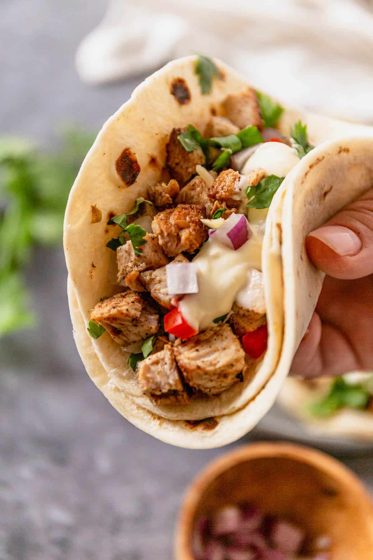 mexican chicken street tacos in hand