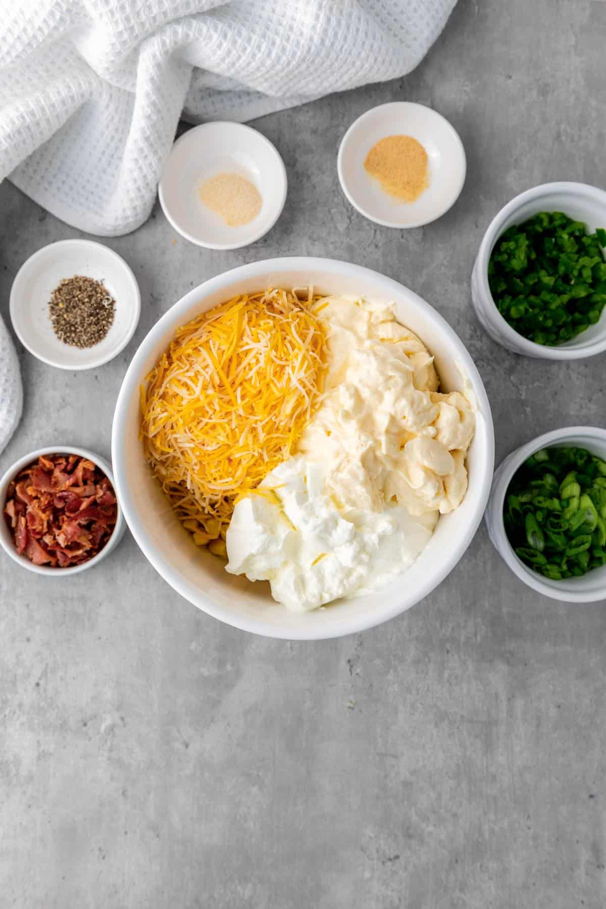 cheese, sour cream and mayo mixed in a bowl